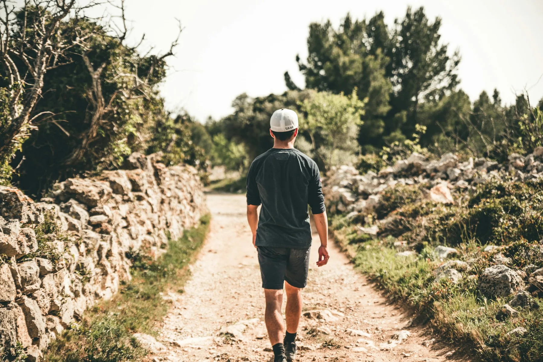 Runner on a stone path through green countryside