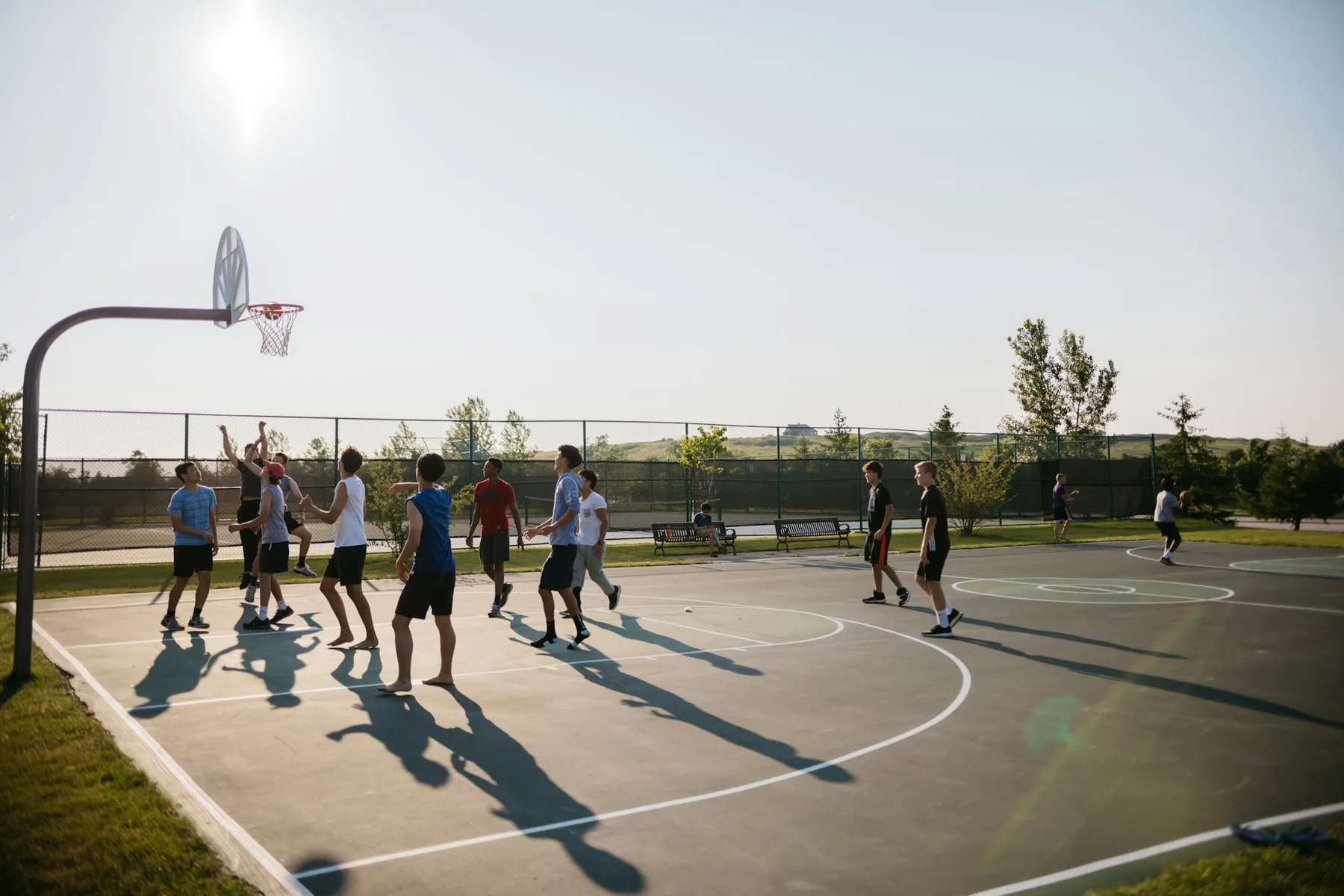 Players on an outdoor basketball court
