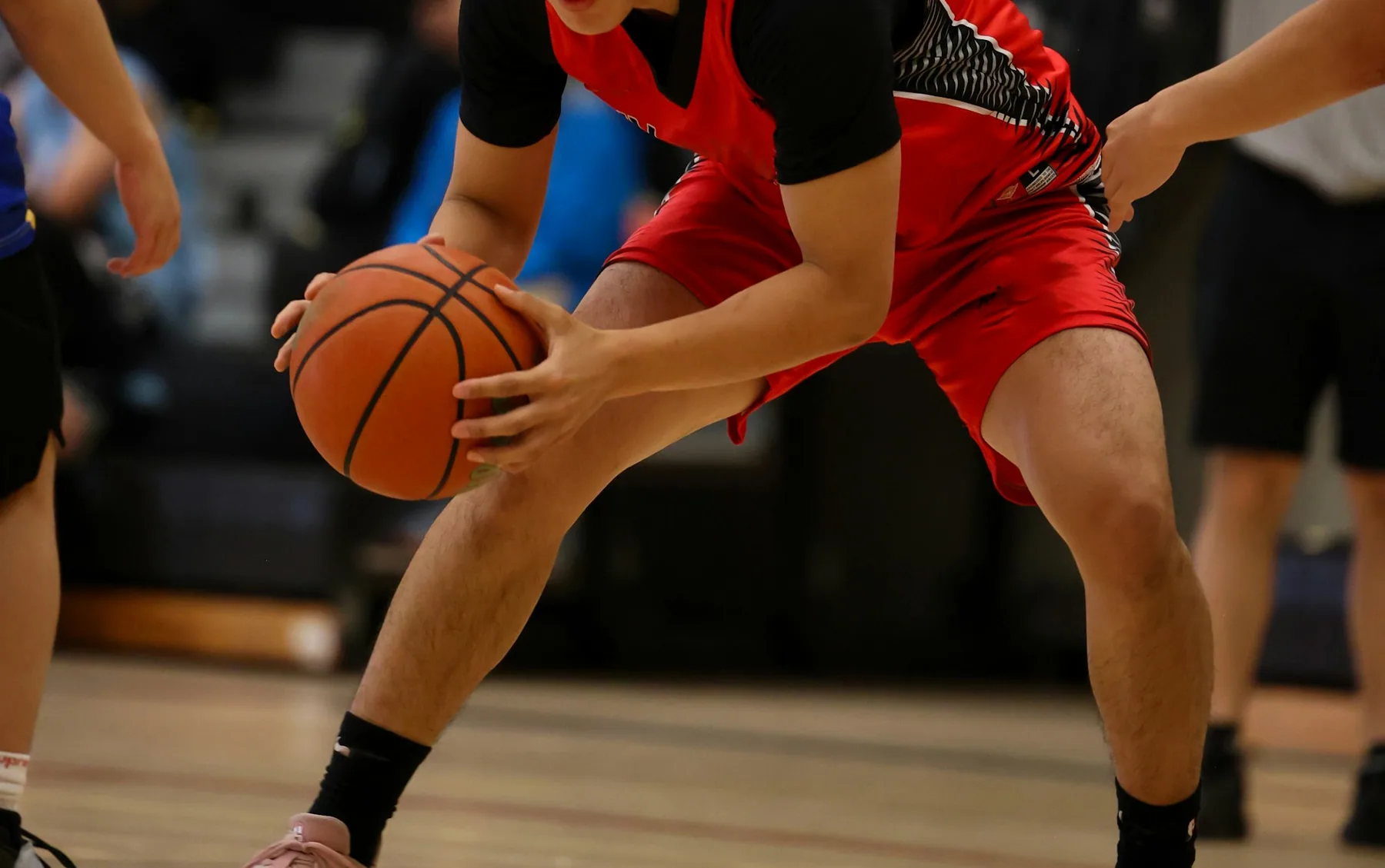 Close view of two players' legs and shorts during a drive to the basket
