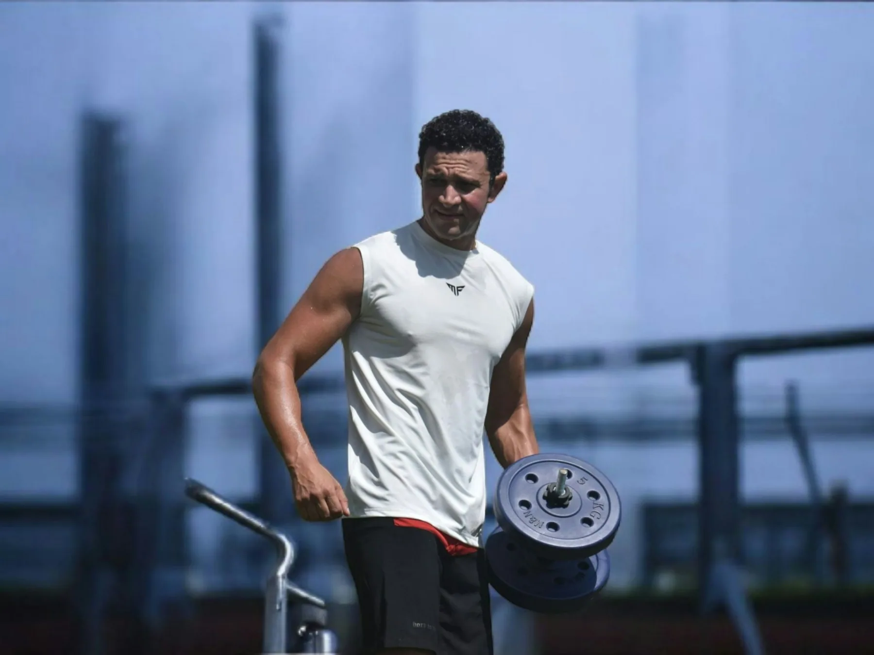 Athlete at a cable machine photographed in black and white