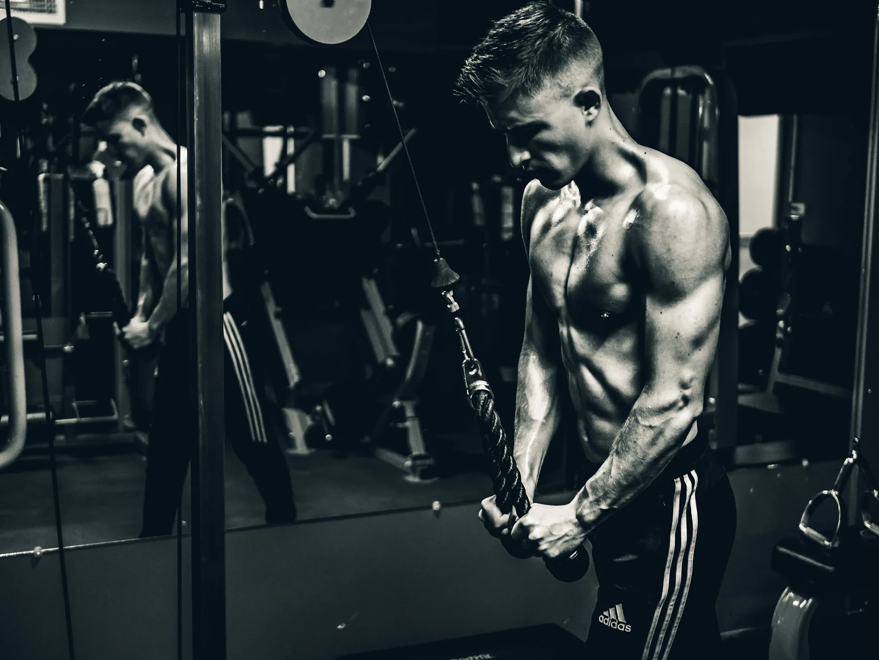 Athlete in a short-sleeved training top in a low-lit gym