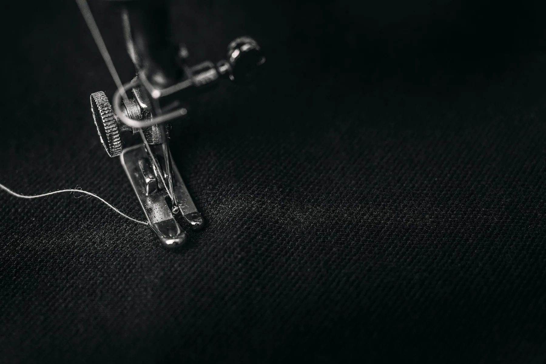 An industrial sewing machine stitching fabric