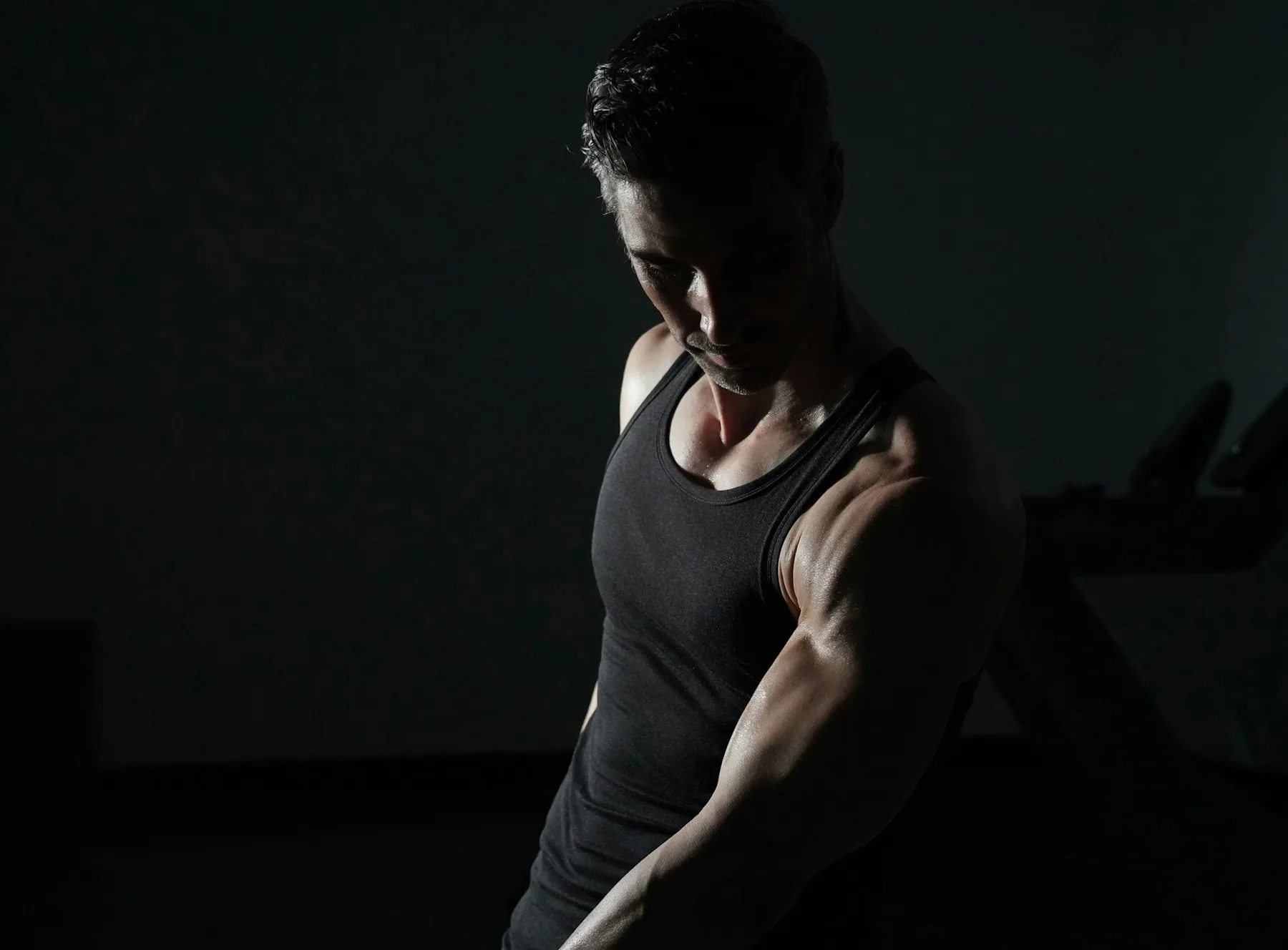 Athlete silhouetted against a dark background after training