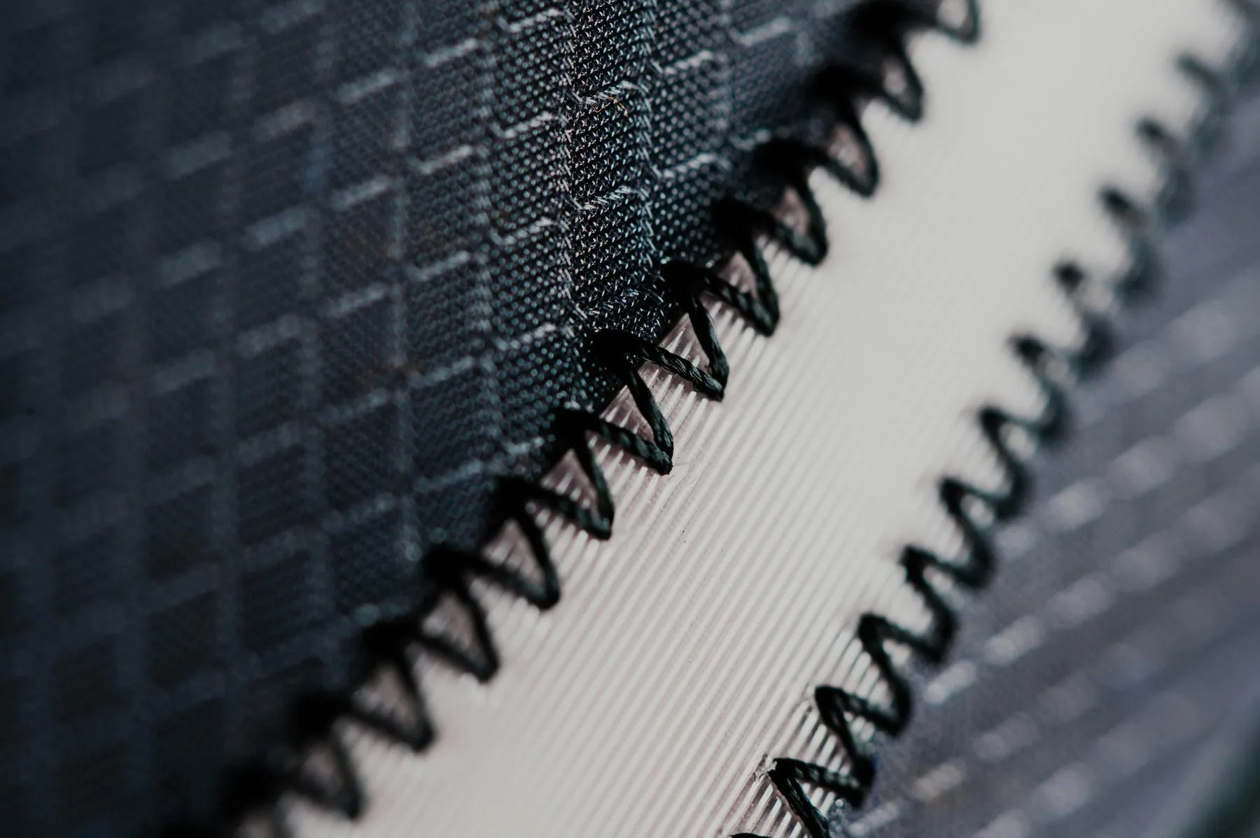 Close detail of technical mesh fabric and flatlock seam stitching
