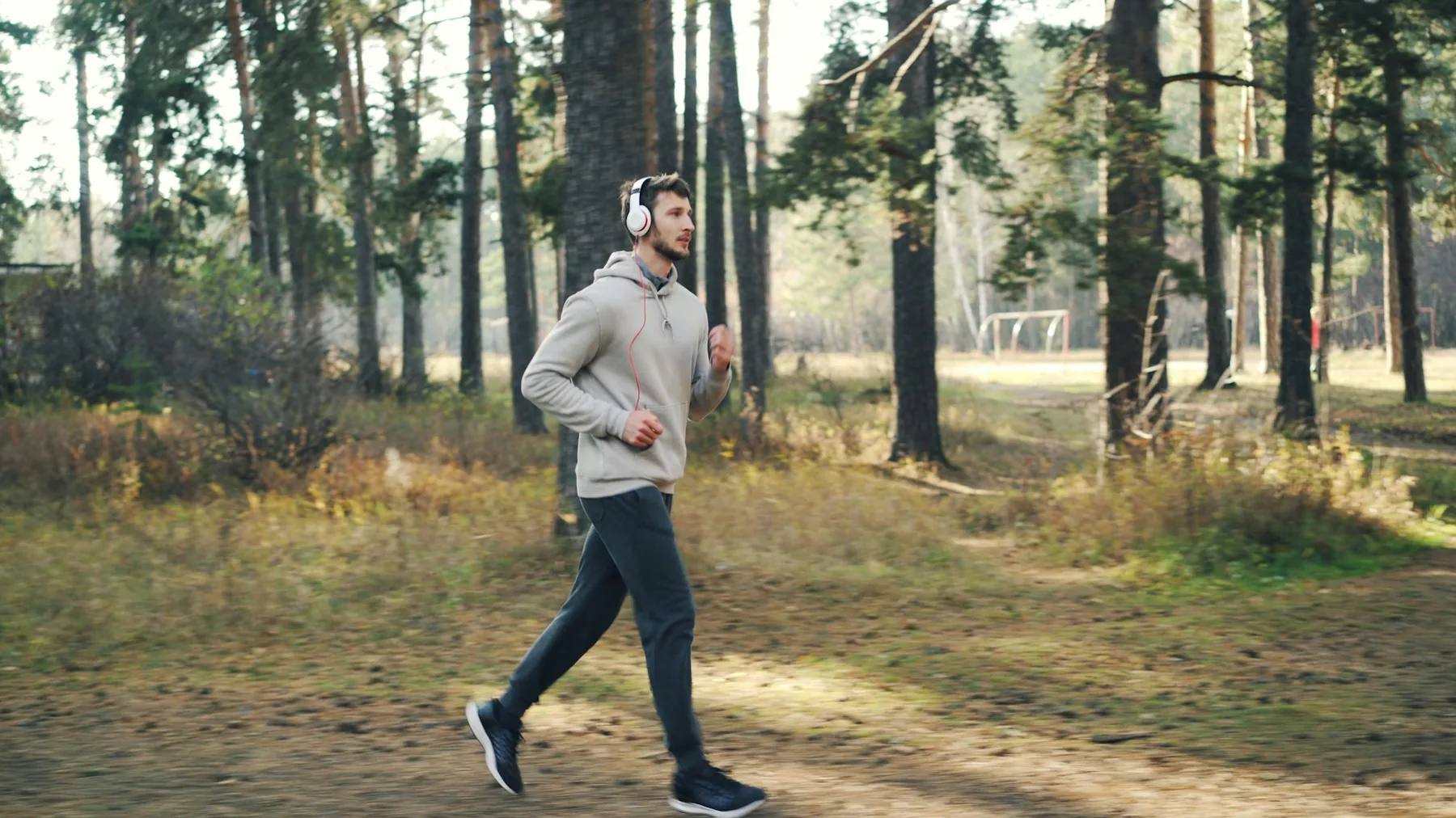 Runner training outdoors in full-length compression tights