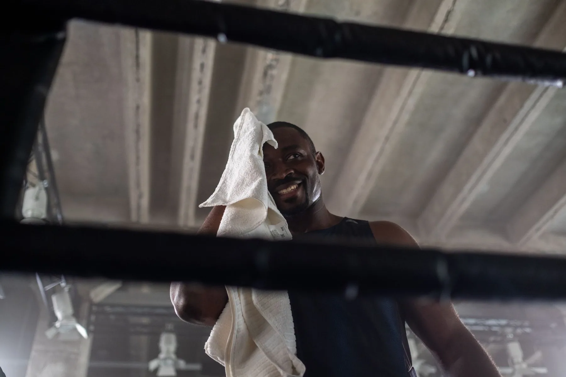 Someone with a towel over one shoulder in a gym