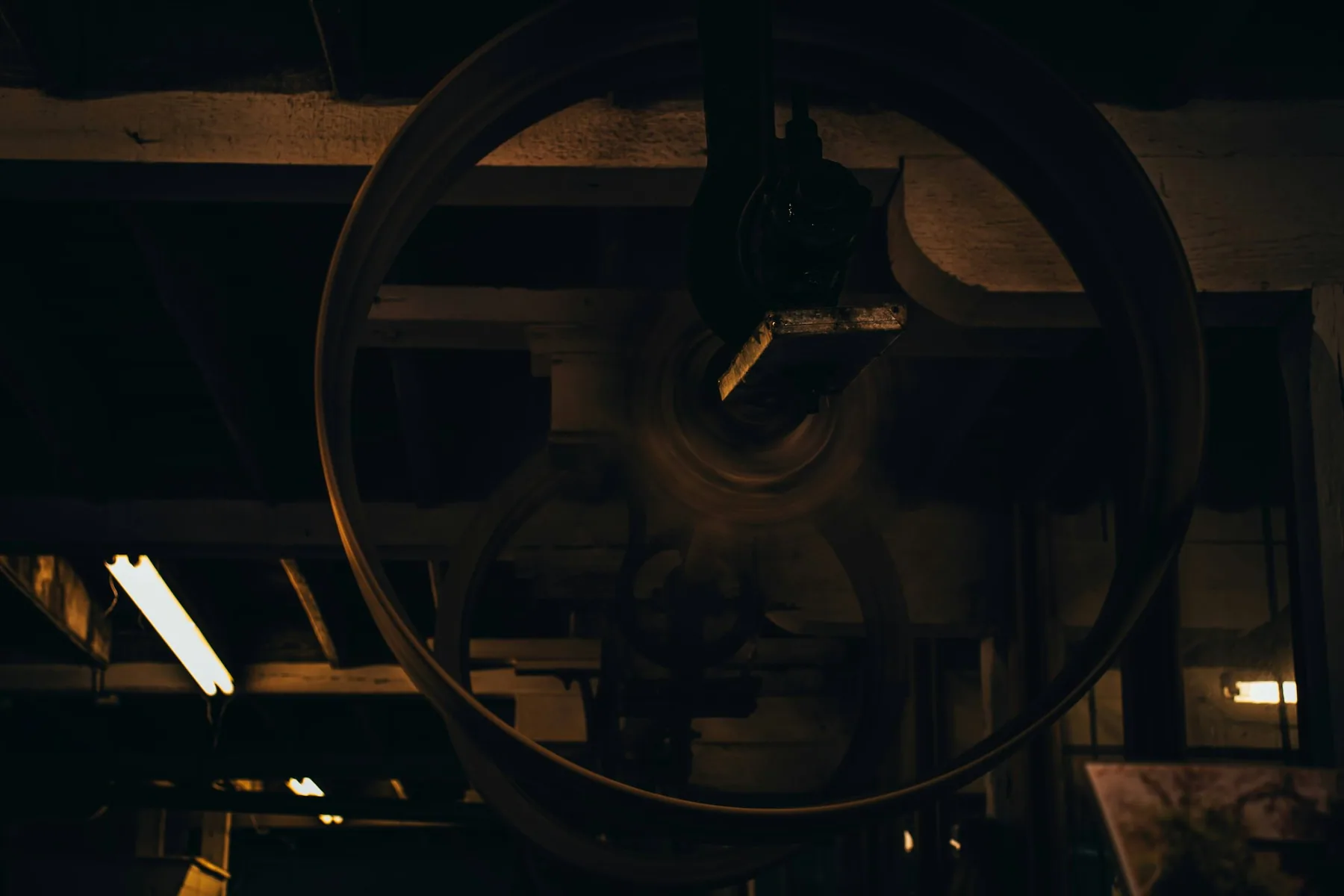 A large wheel in a dim interior
