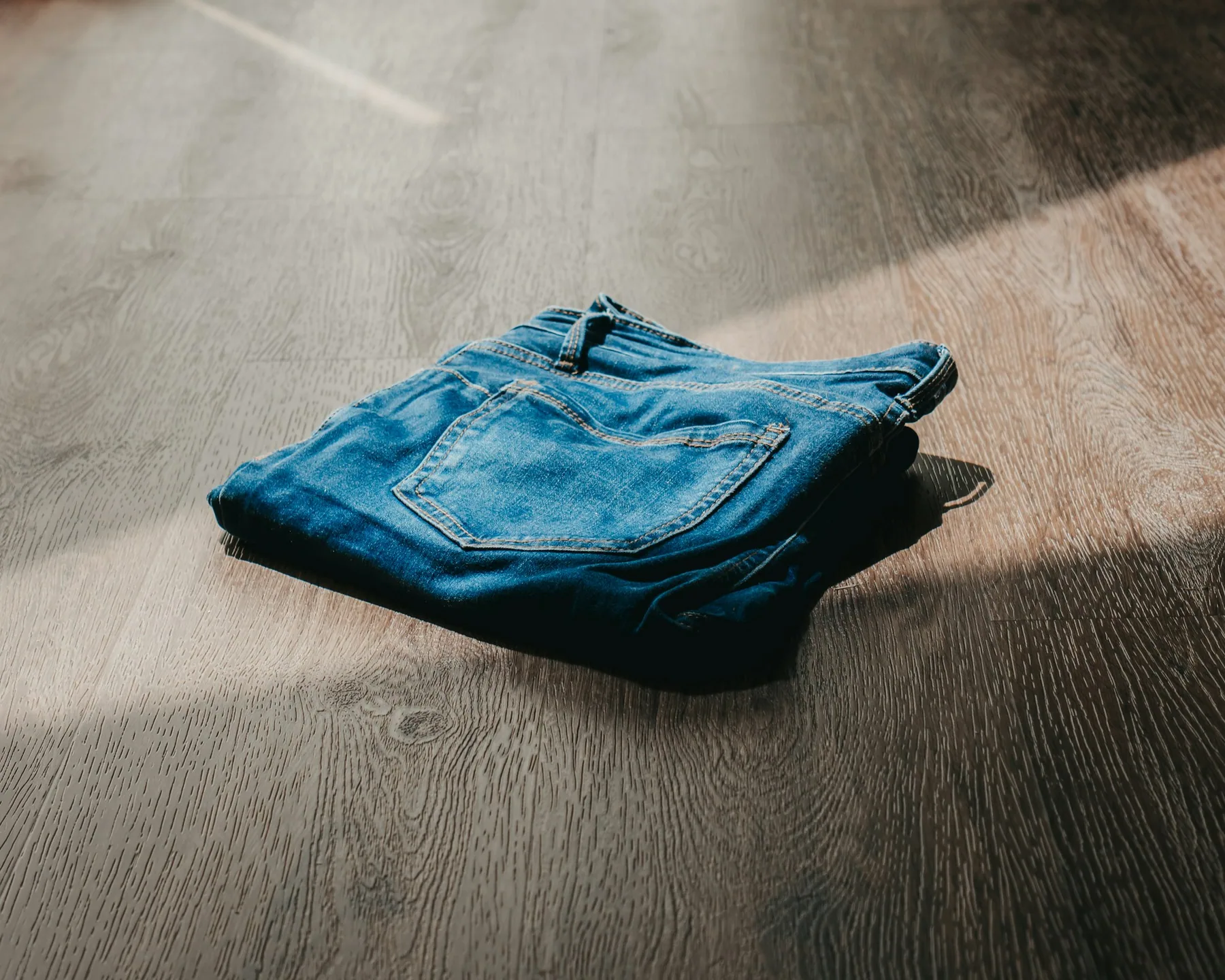 A single folded garment on a bare floor
