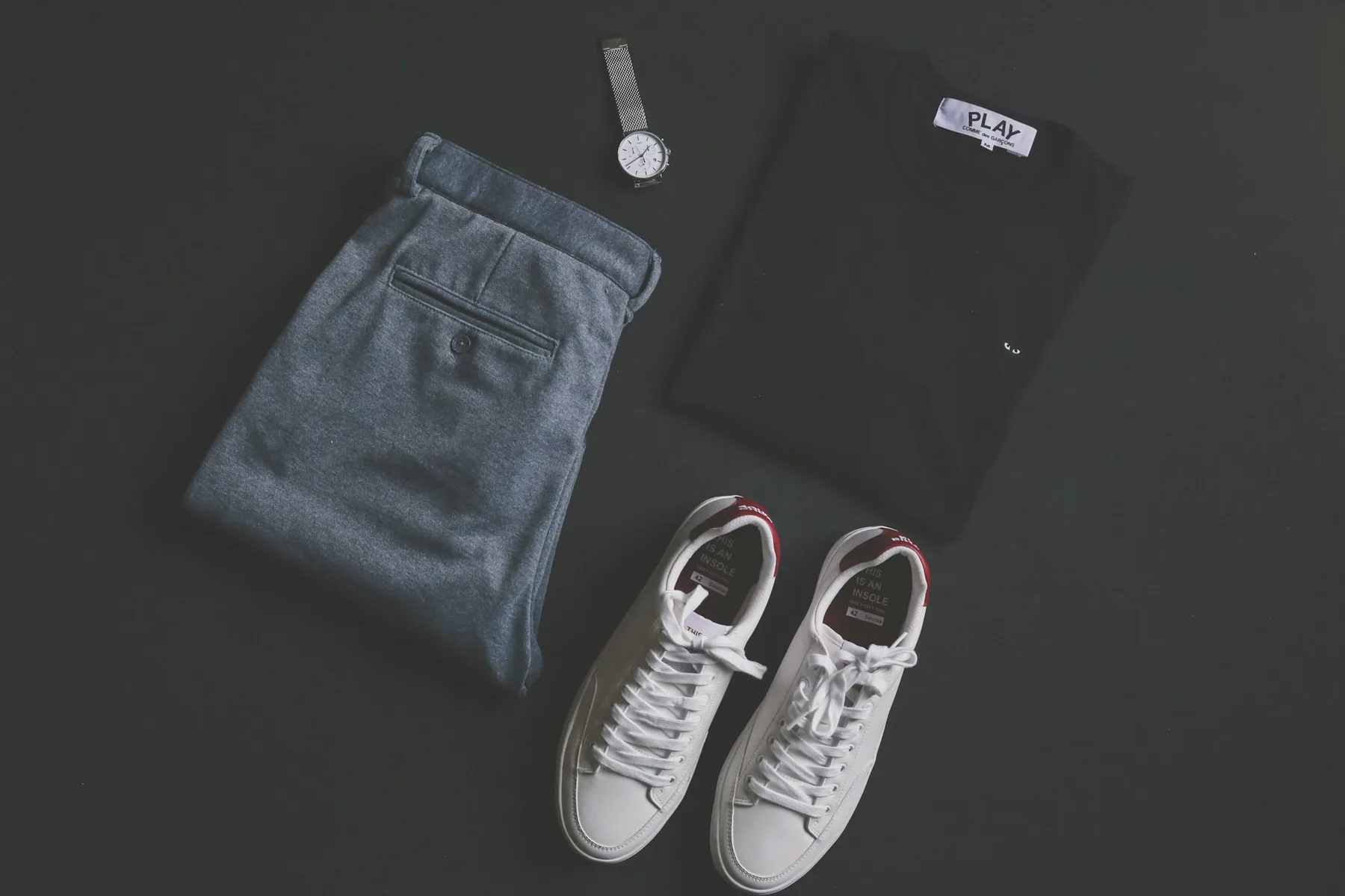 Plain shorts and training shoes laid flat