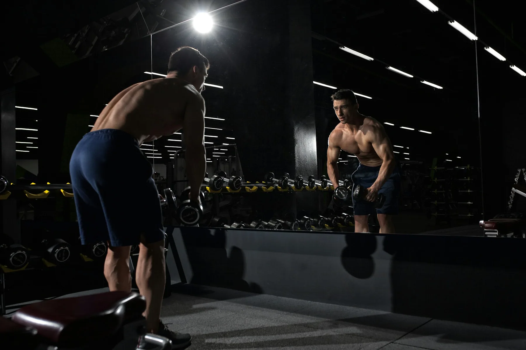Someone training in front of a gym mirror