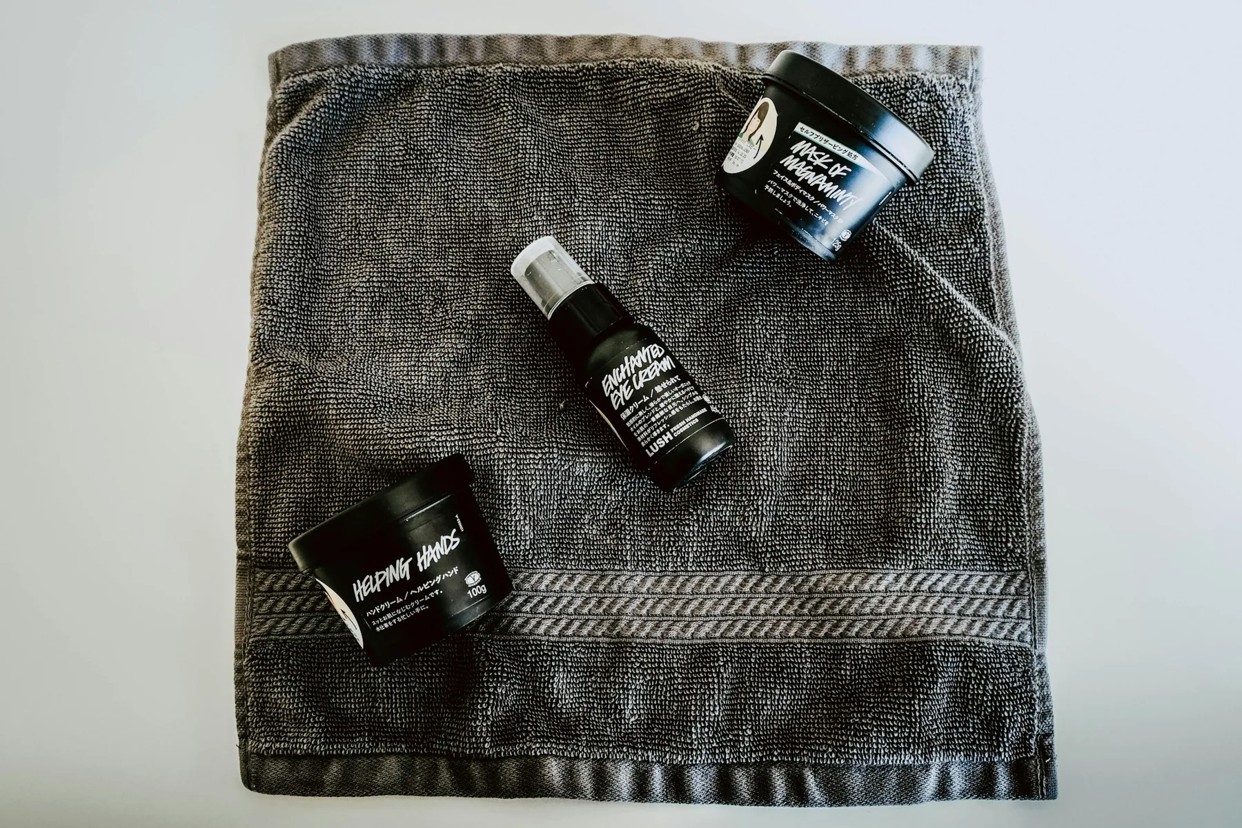 A training bag and dumbbell beside a mat