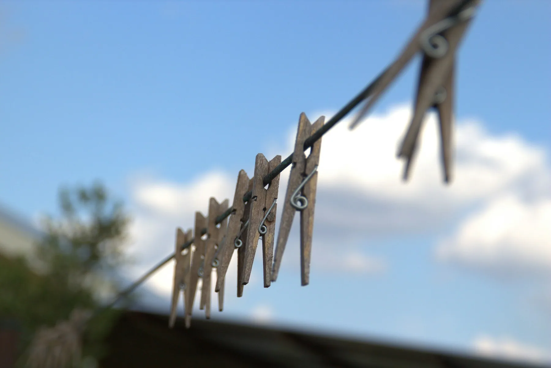 A clothes peg on a washing line against open sky