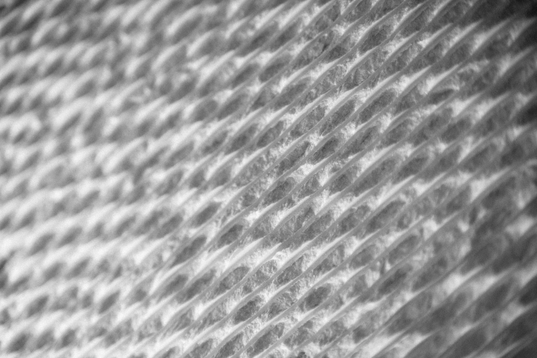 Macro detail of a knitted fabric weave in black and white
