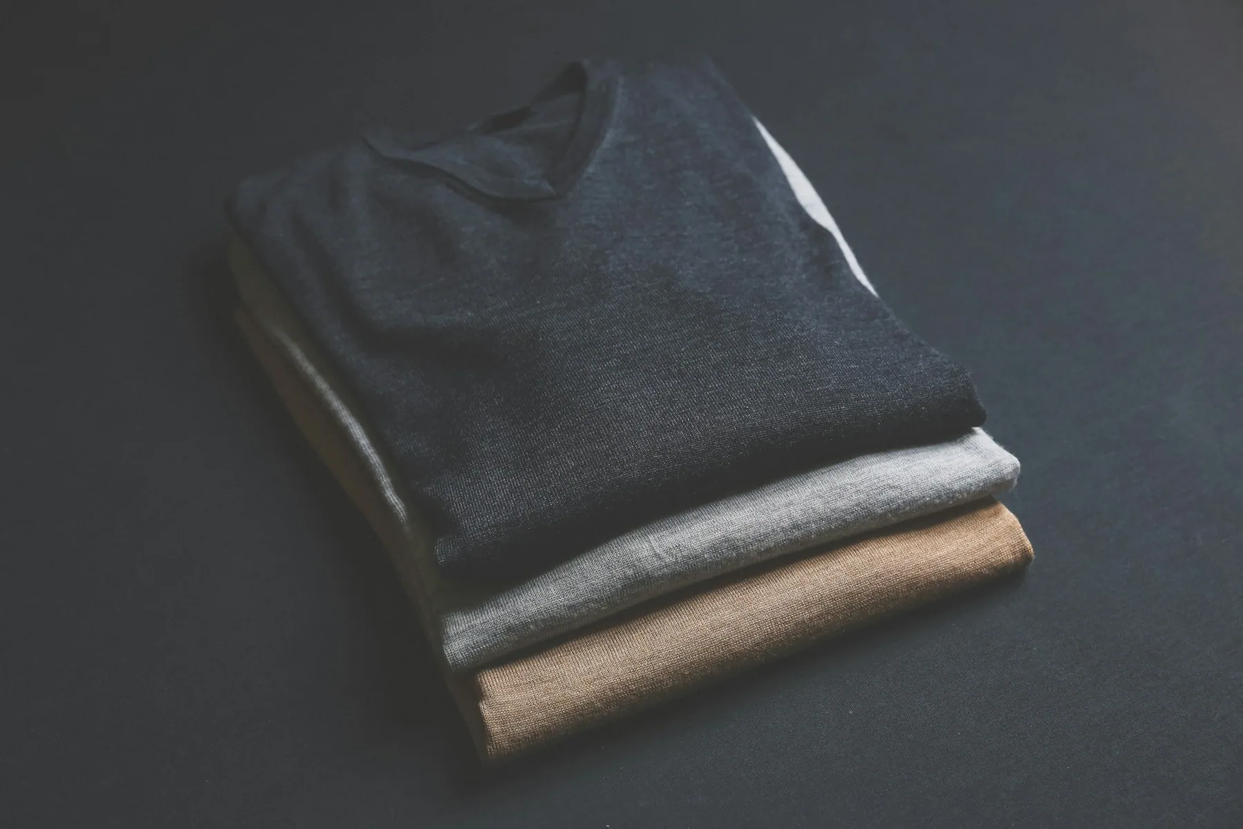 Folded training garments on a dark surface