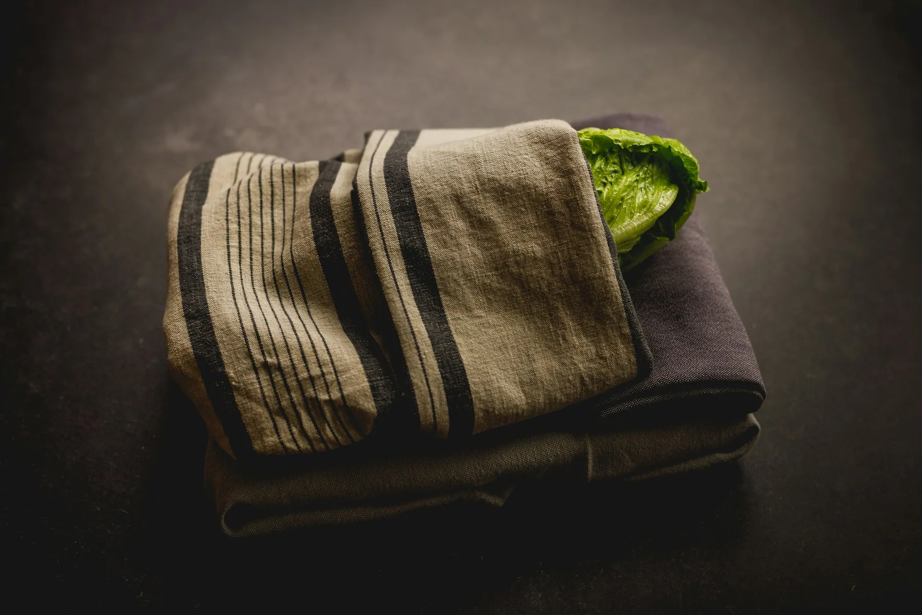 A folded stack of training clothes lit against a dark background