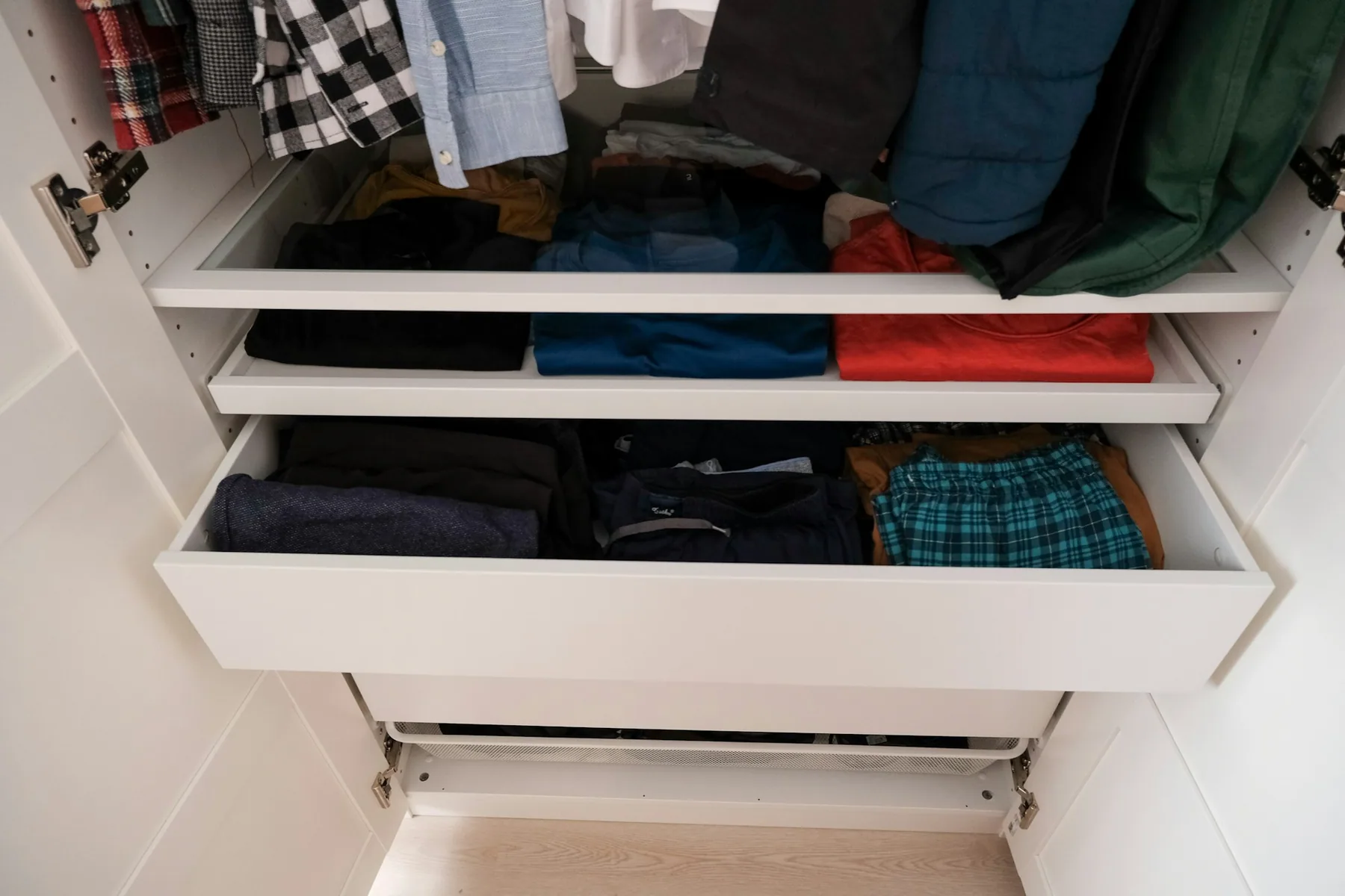 Dark clothing hanging on an open rail