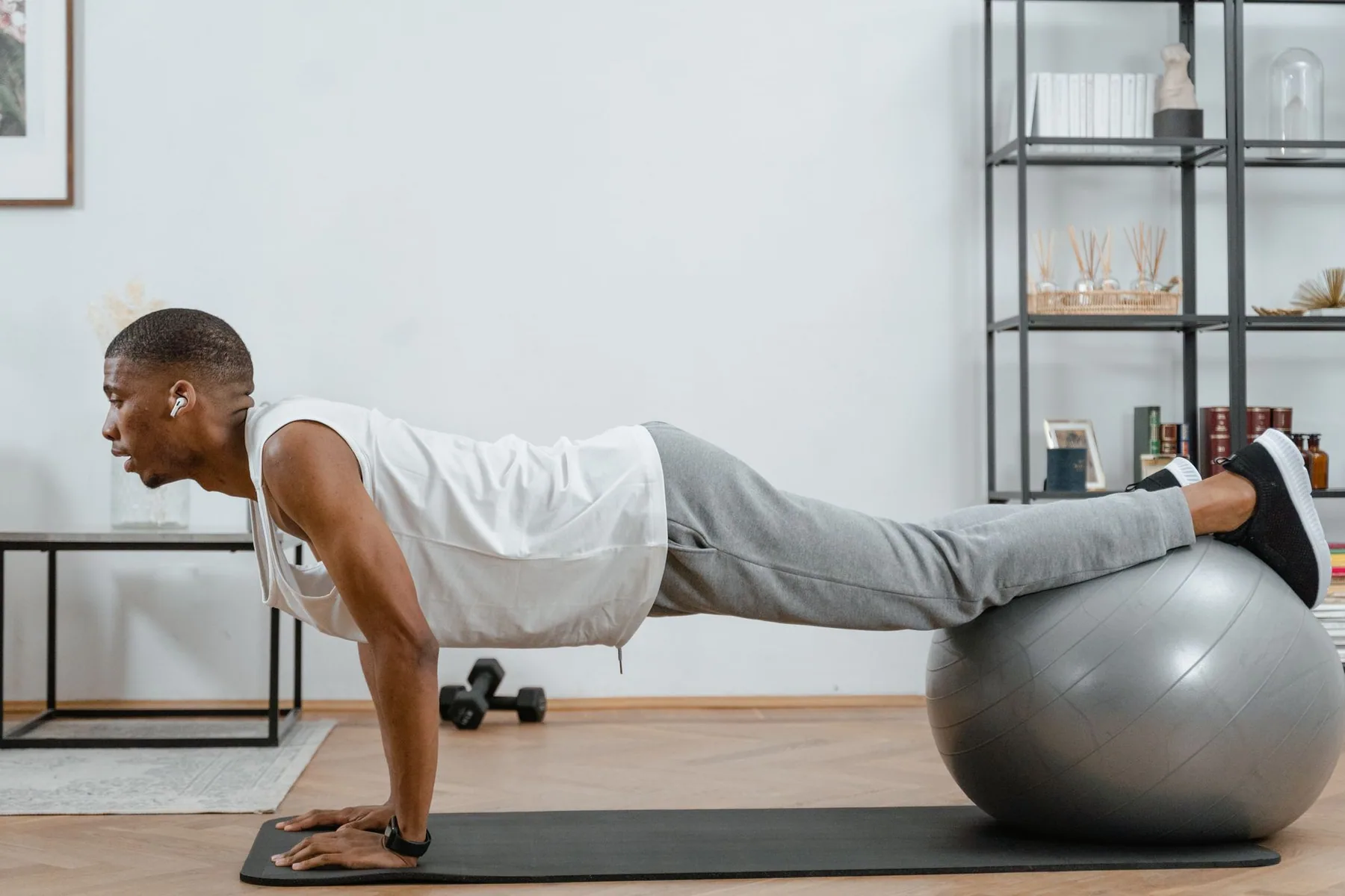 Someone doing a press-up over an exercise ball at home
