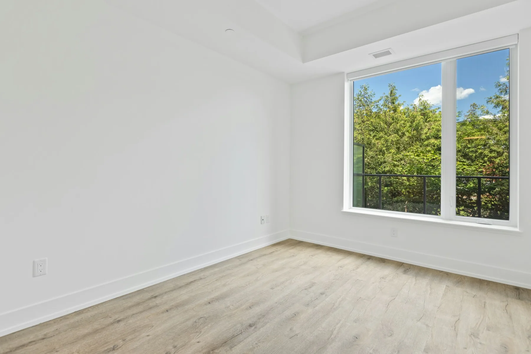 The corner of an empty room with a window