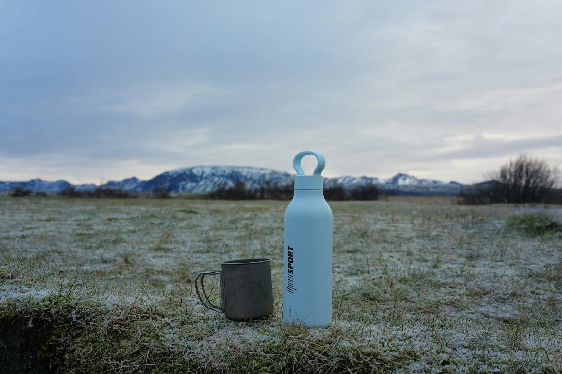 A water bottle set down on open ground