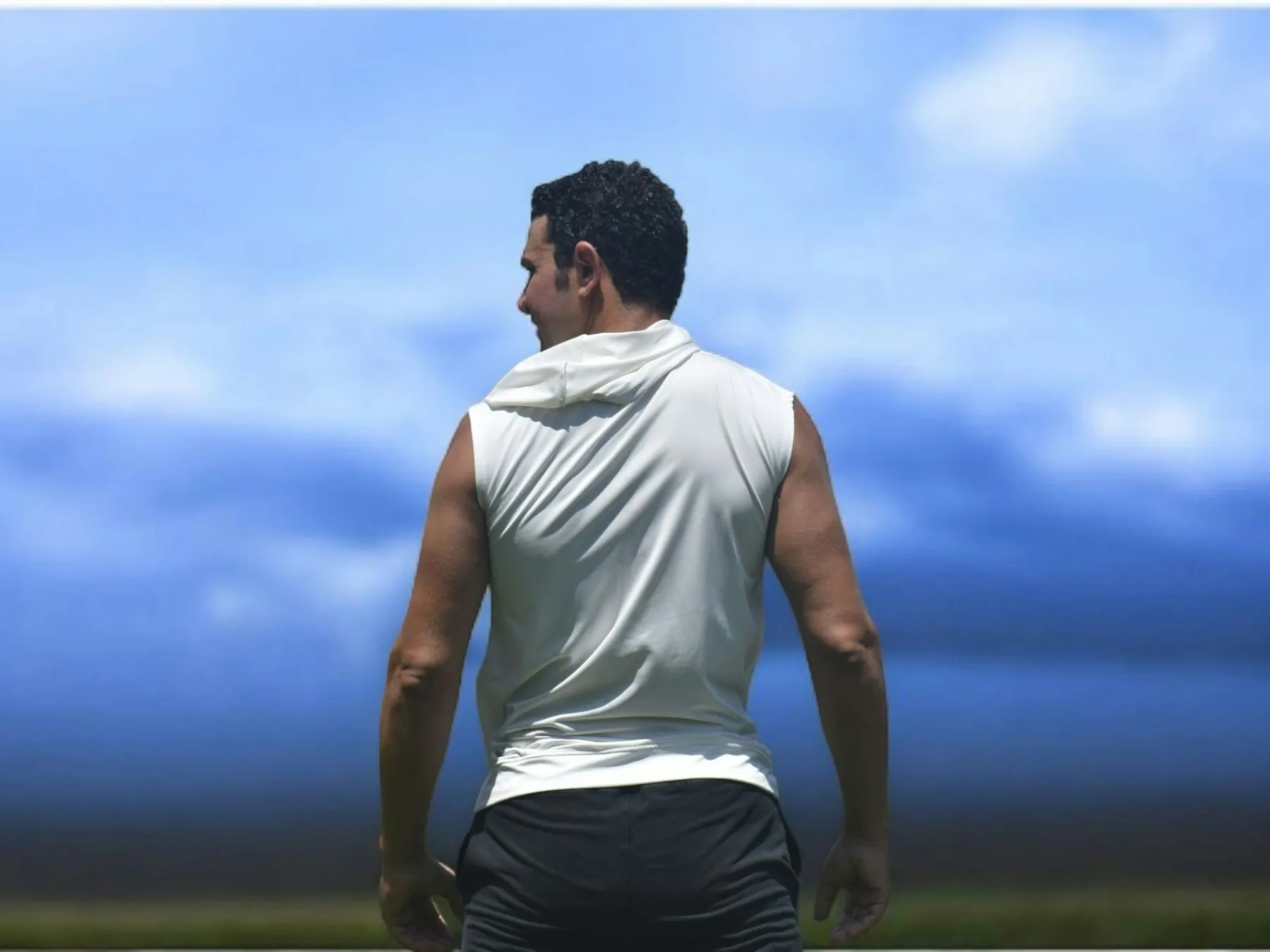 Athlete in a sleeveless top under open sky