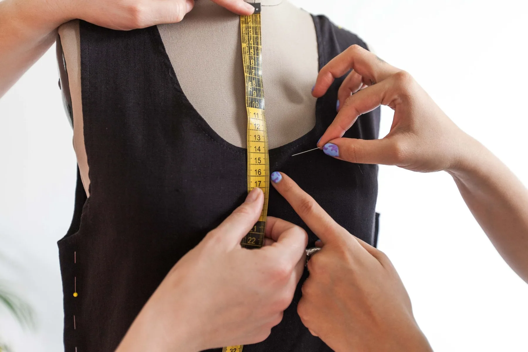 A tape measure held against a garment