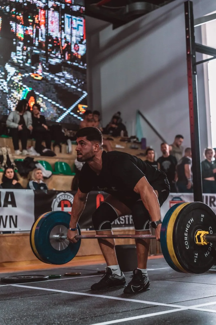 Barbell training in a dark gym