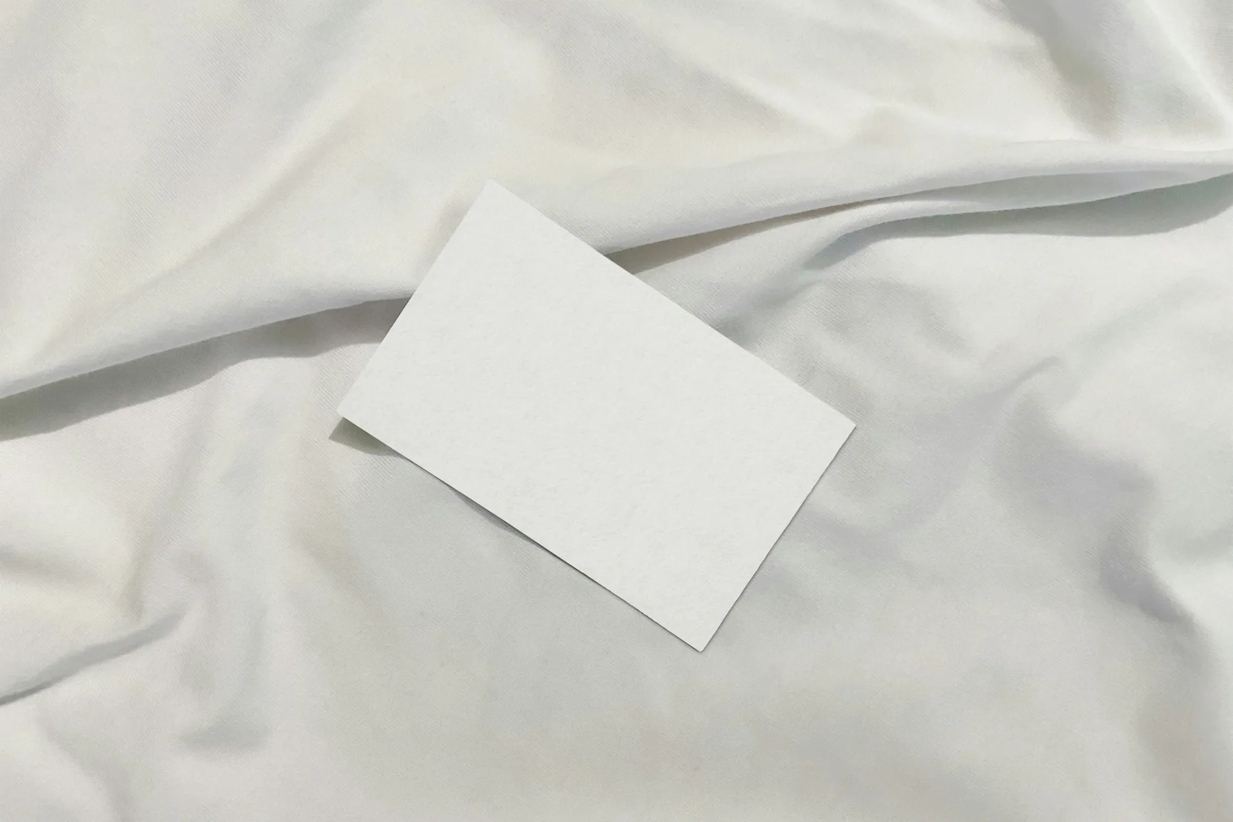 A blank label resting on pale folded fabric