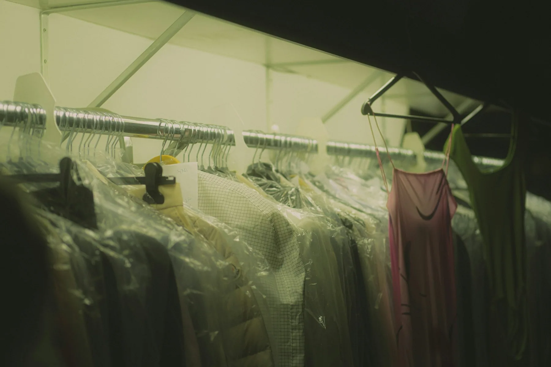A rail of clothing in muted light