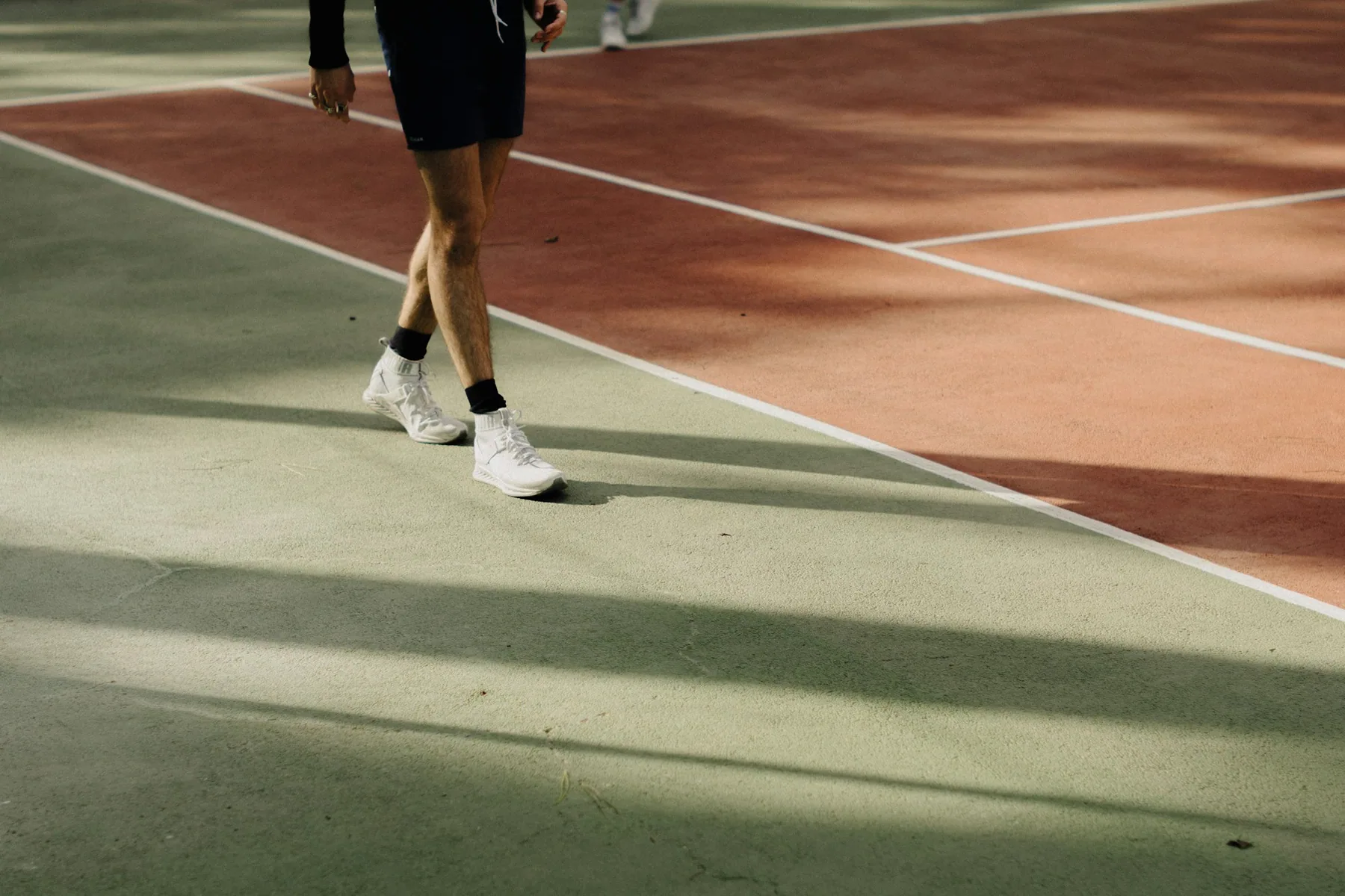 A runner on a track in low light