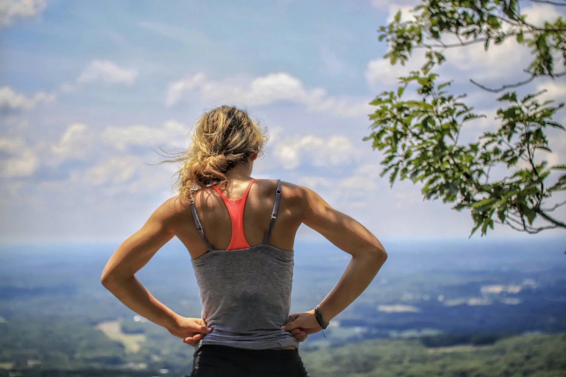 The back of a racerback sports bra worn under a training vest
