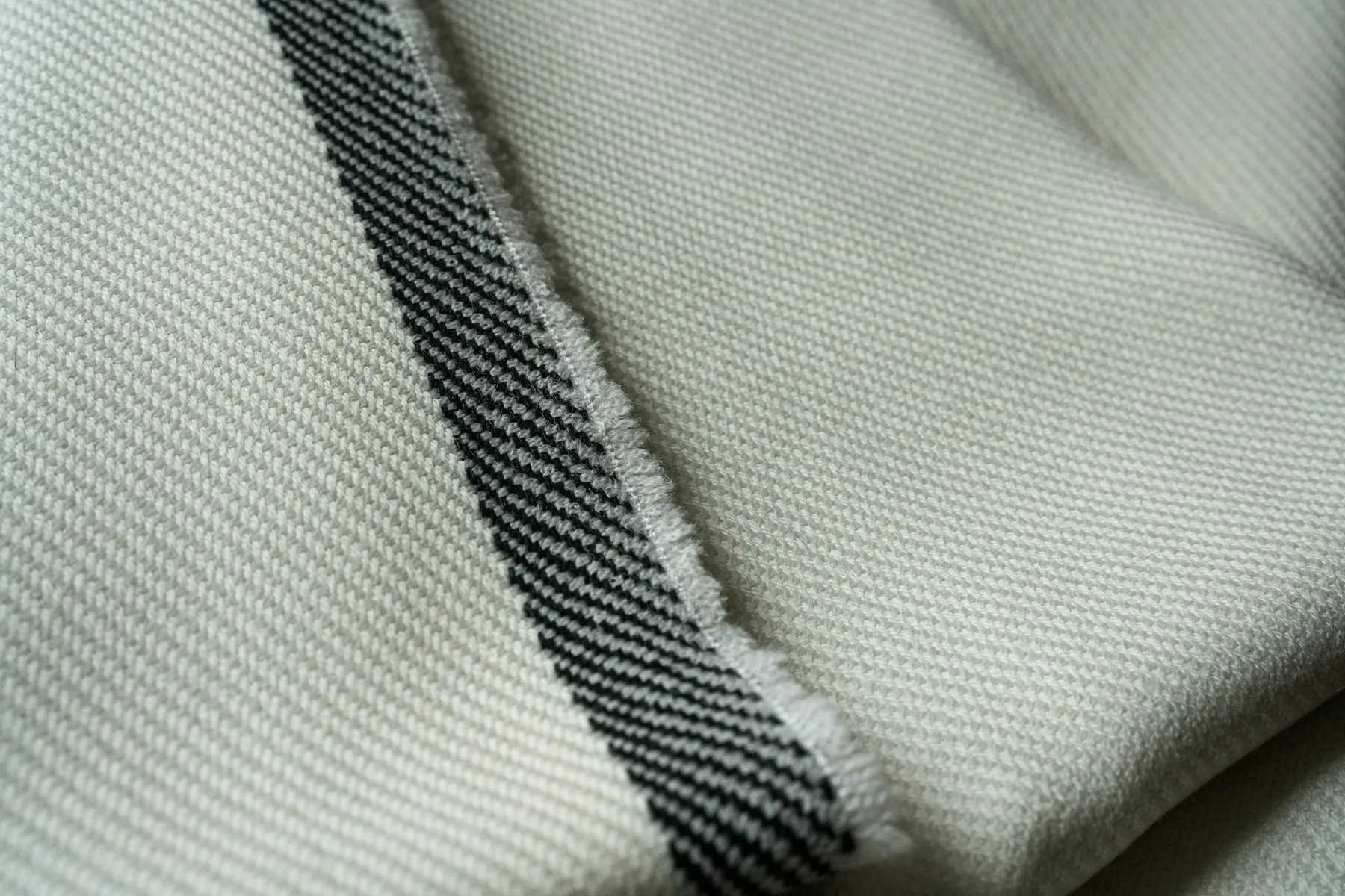 Close detail of a woven band on pale fabric