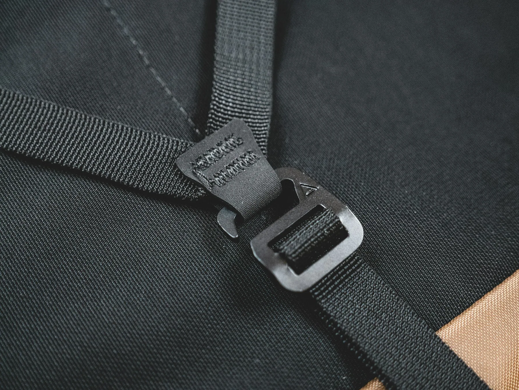 Close detail of a dark strap and adjuster