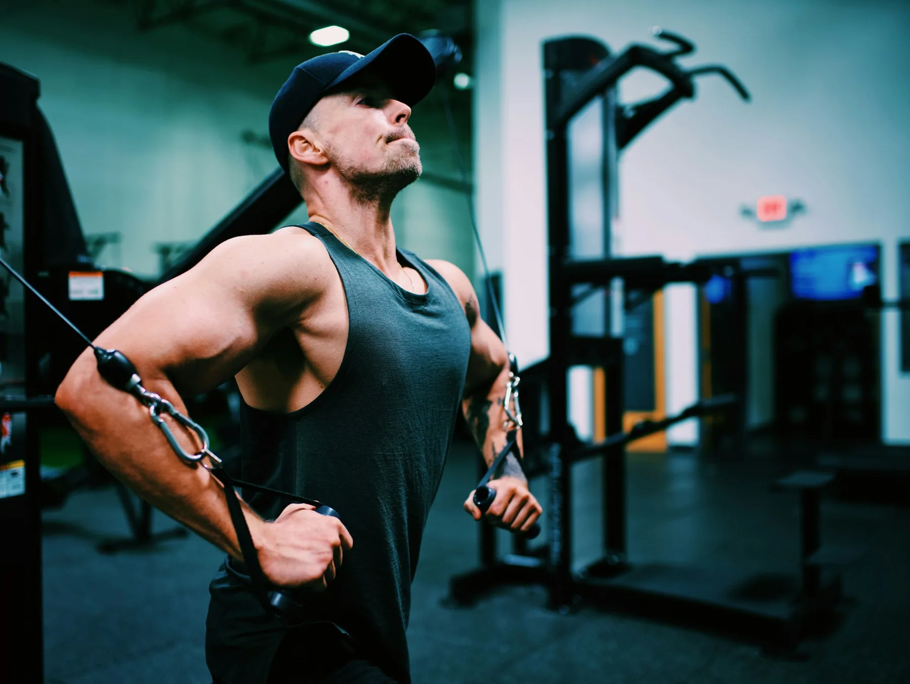 Athlete working on a cable machine in a sleeveless top