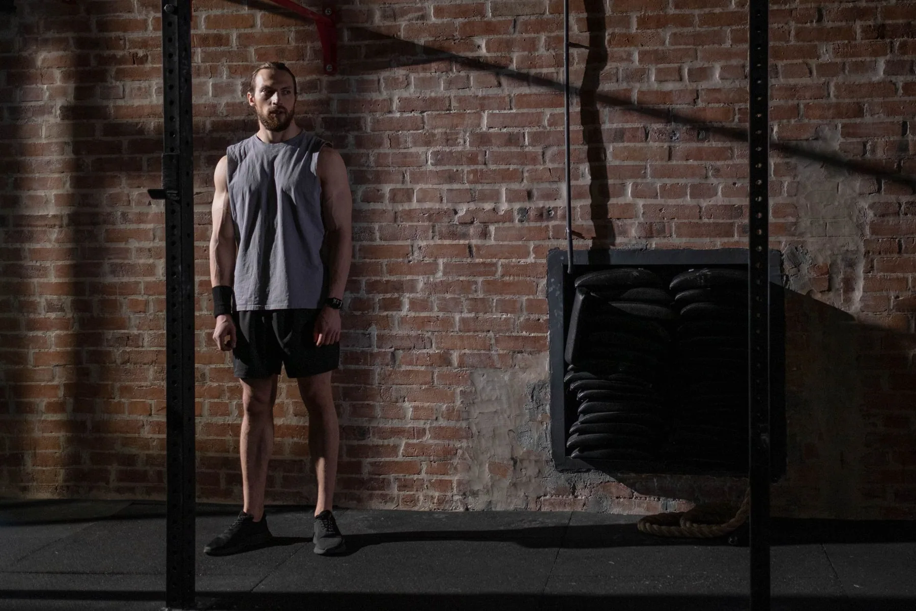 Athlete training alone in a dark brick gym