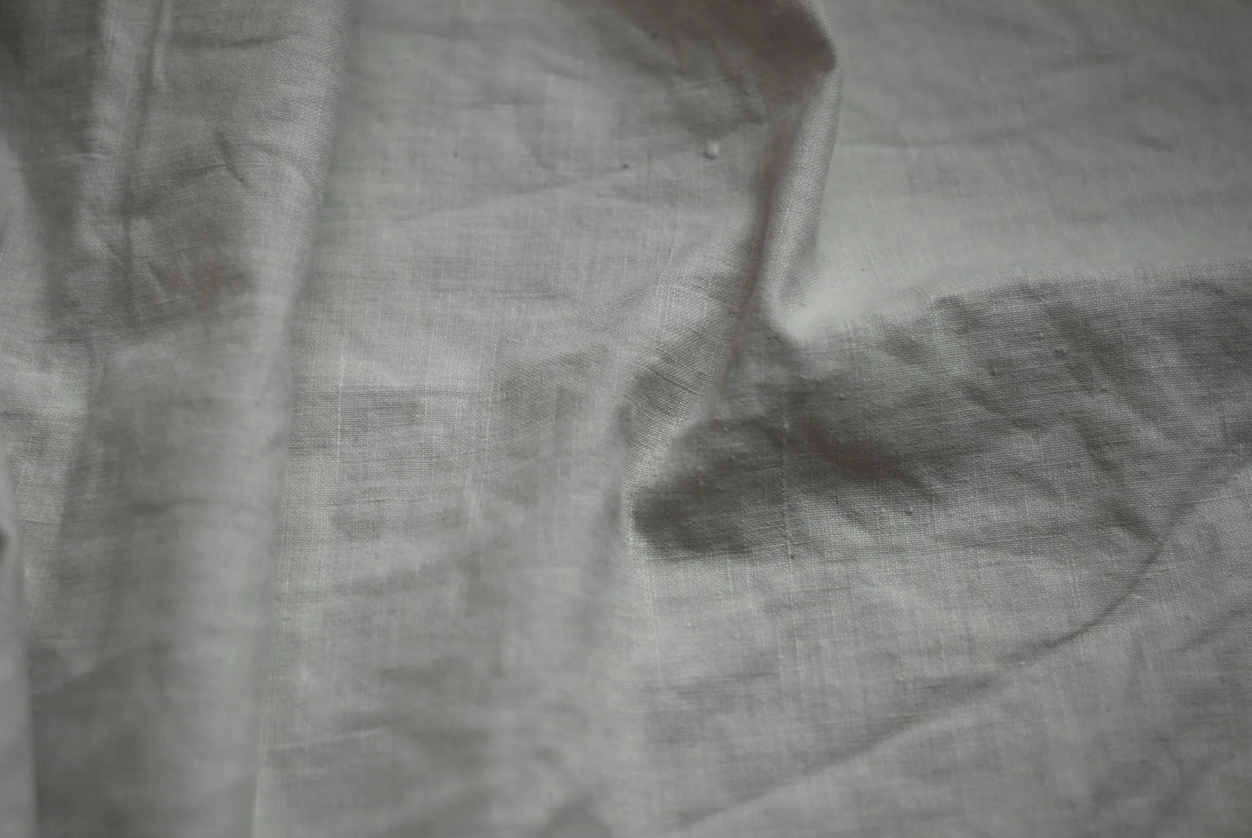 Hands treating fabric in a sink