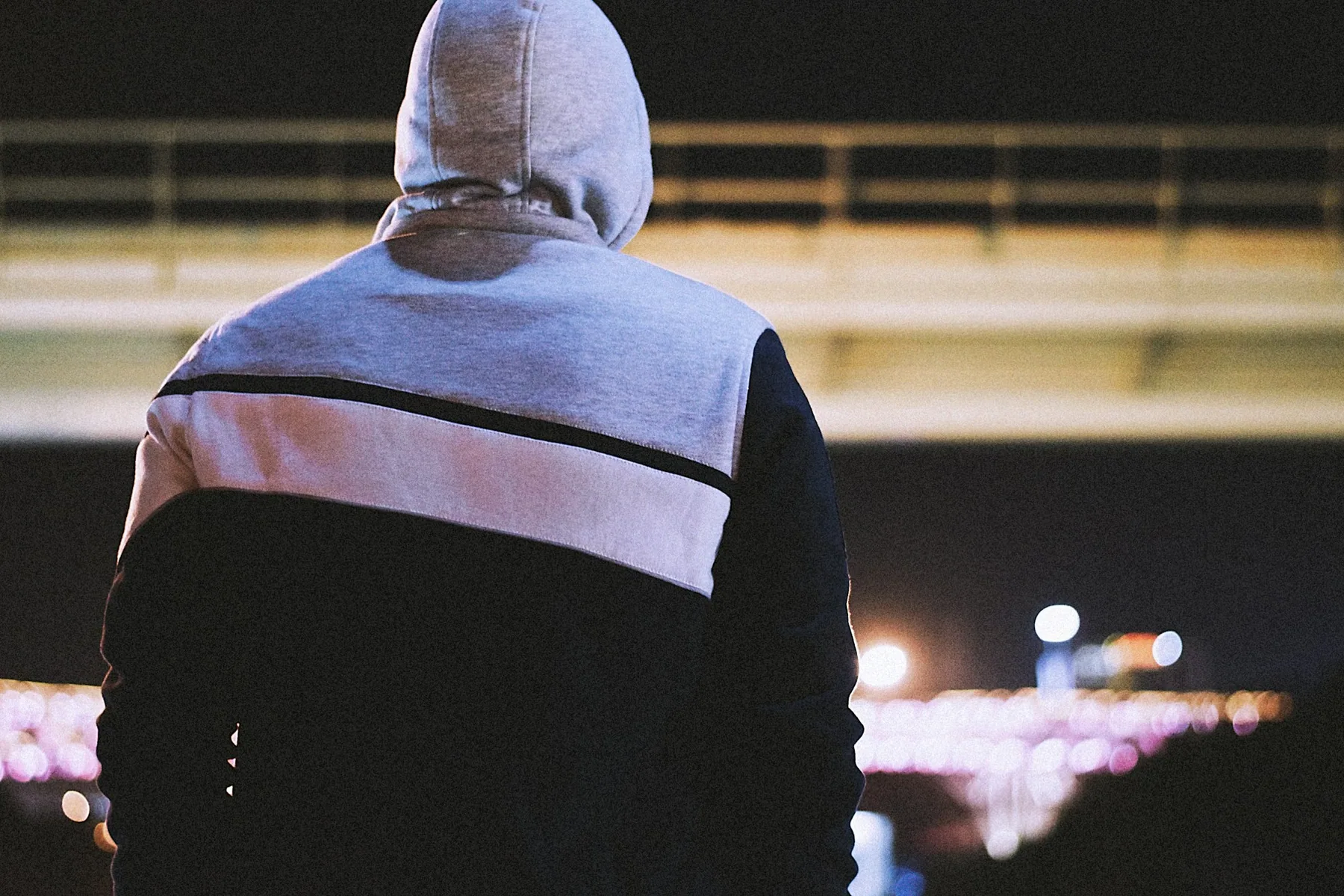 The back of a hooded top with a pale panel across the shoulders
