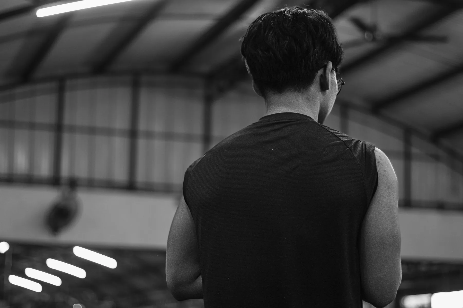 Back view of a sleeveless training top showing the armhole and shoulder